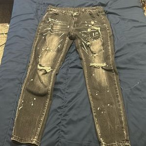 Ripped black paint splattered jeans